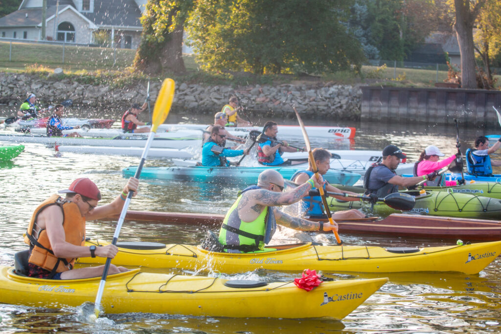 kayakers and canoers on Kawkawlin River for Driathlon 2024